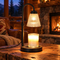 Black candle warmer lamp glowing over a jar candle in a cabin living room