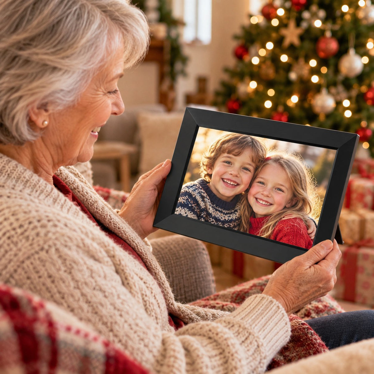 Grandmother looking at photos on the WiFi digital photo frame